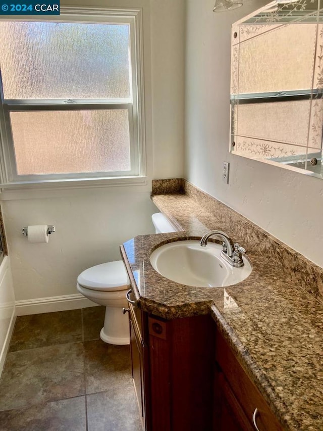 bathroom with tile patterned floors, vanity, and toilet