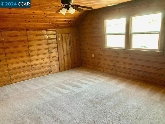 bonus room with carpet flooring, wooden walls, lofted ceiling, and wood ceiling