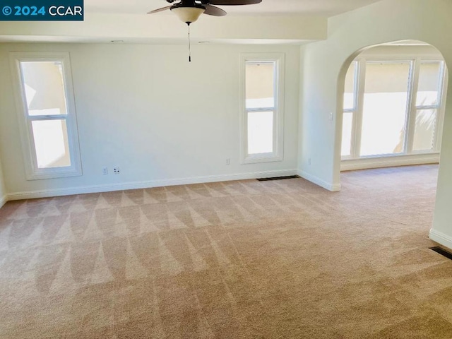 unfurnished room featuring ceiling fan and light colored carpet