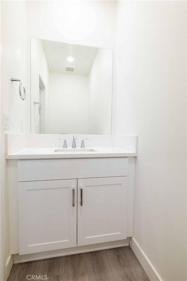 bathroom featuring hardwood / wood-style flooring and vanity