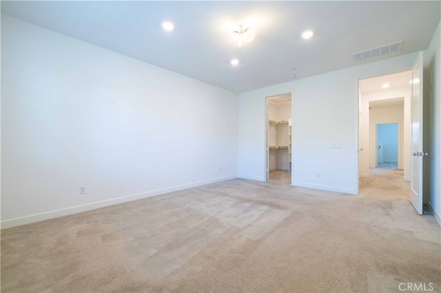 unfurnished room featuring light carpet