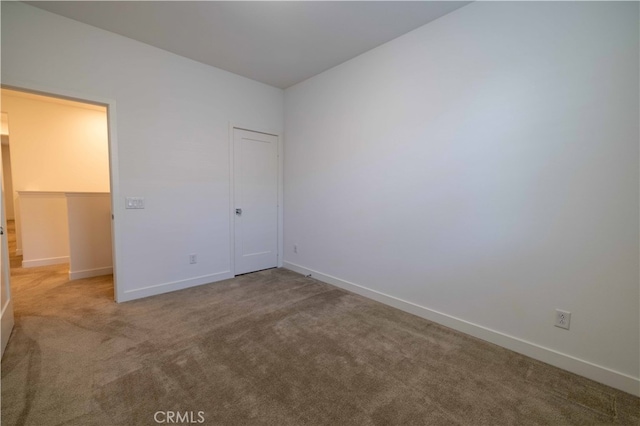 unfurnished bedroom featuring a closet and carpet flooring