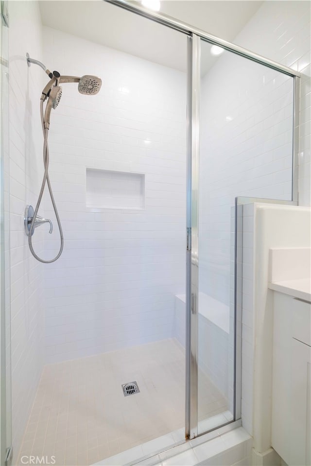 bathroom featuring vanity and a shower with shower door