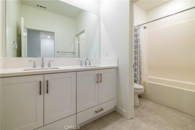 full bathroom featuring tile patterned flooring, vanity, toilet, and shower / bath combination with curtain