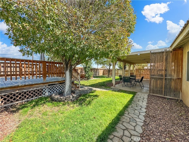 view of yard featuring a patio and a deck