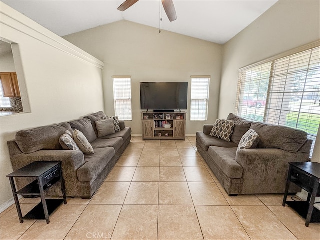 living room with lofted ceiling, ceiling fan, and light tile patterned floors