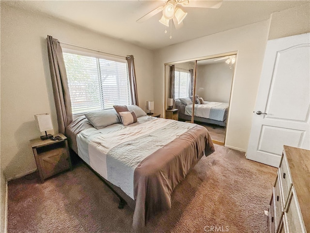 carpeted bedroom featuring a closet, multiple windows, and ceiling fan