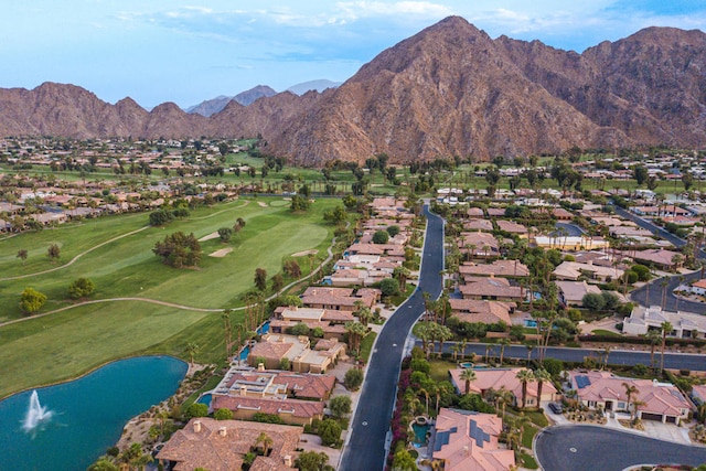 birds eye view of property with a water and mountain view