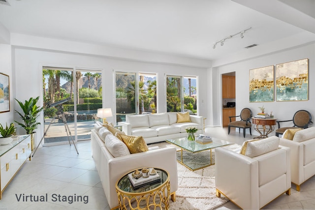 tiled living room with track lighting and a healthy amount of sunlight