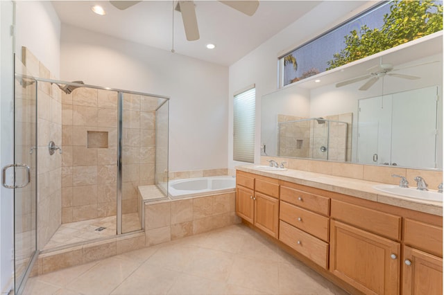 bathroom featuring vanity, ceiling fan, plus walk in shower, and tile patterned floors