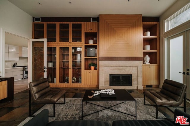 living room with a fireplace and dark wood-type flooring