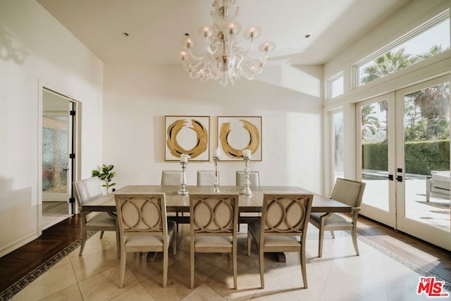 tiled dining room with french doors and an inviting chandelier