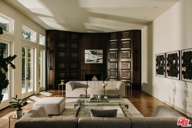 living room with french doors, a fireplace, and parquet floors