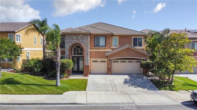 view of front property with french doors, a front yard, and a garage