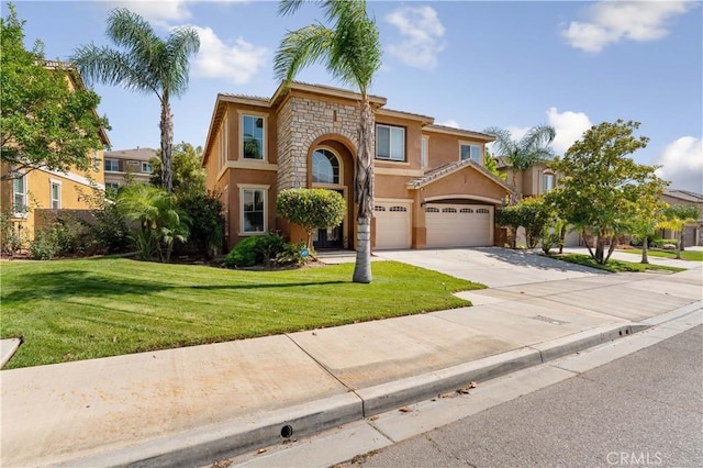 mediterranean / spanish-style house featuring a front yard and a garage