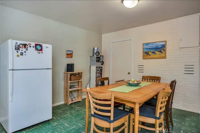 dining space with tile patterned floors and baseboards