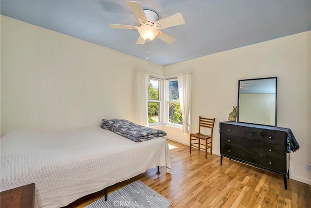 bedroom featuring wood finished floors and ceiling fan