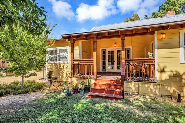 back of property featuring french doors and covered porch