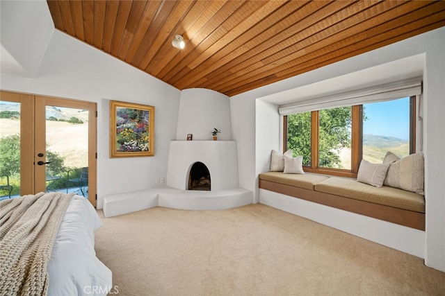 carpeted bedroom with access to outside, wood ceiling, french doors, a fireplace, and vaulted ceiling