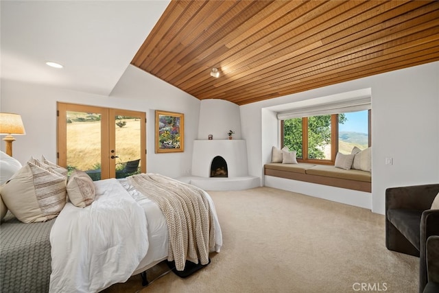 carpeted bedroom featuring wooden ceiling, lofted ceiling, a large fireplace, french doors, and access to outside