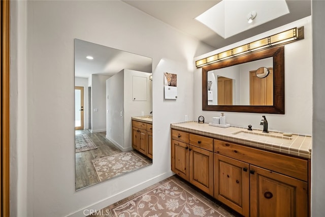 bathroom featuring hardwood / wood-style flooring and vanity