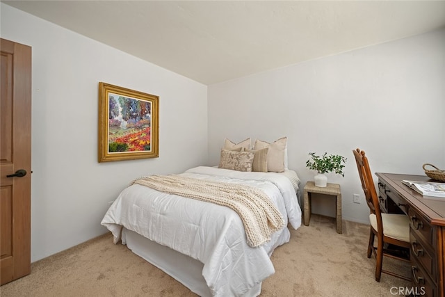 bedroom featuring light carpet