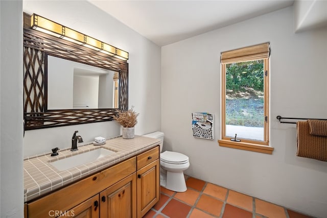 bathroom featuring vanity, tile patterned flooring, and toilet