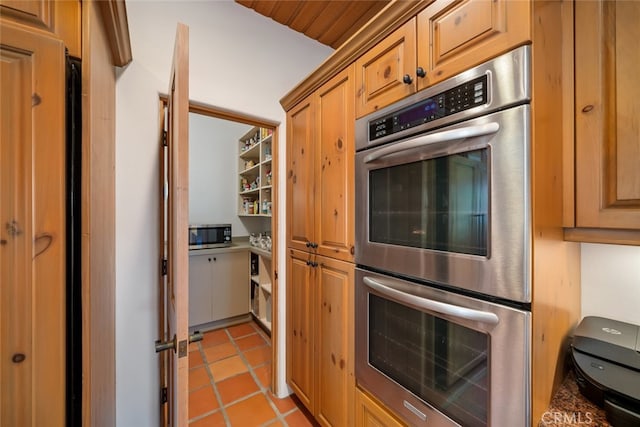 kitchen featuring stainless steel appliances and wood ceiling