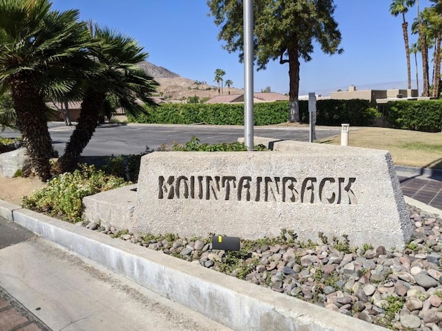 community sign with a mountain view