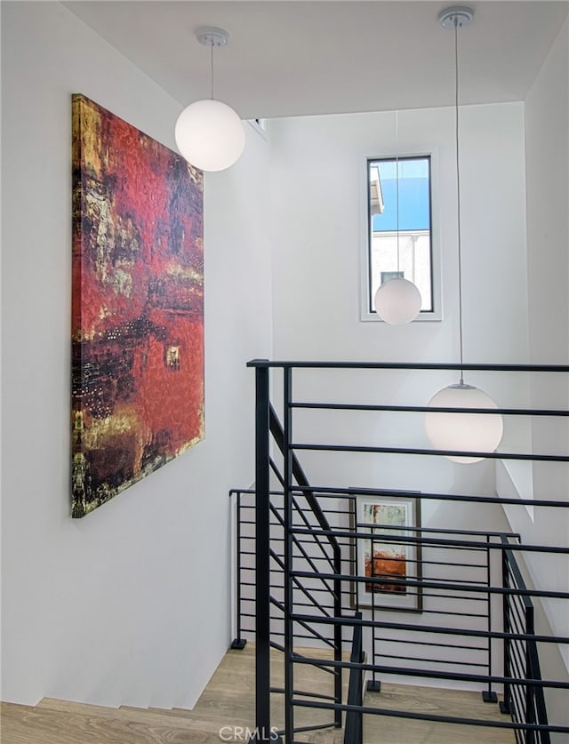 stairs featuring hardwood / wood-style floors