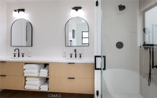 bathroom with vanity, an enclosed shower, backsplash, and tile walls