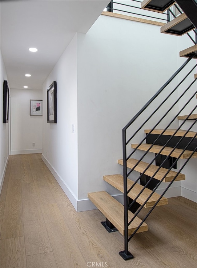 stairs with hardwood / wood-style flooring