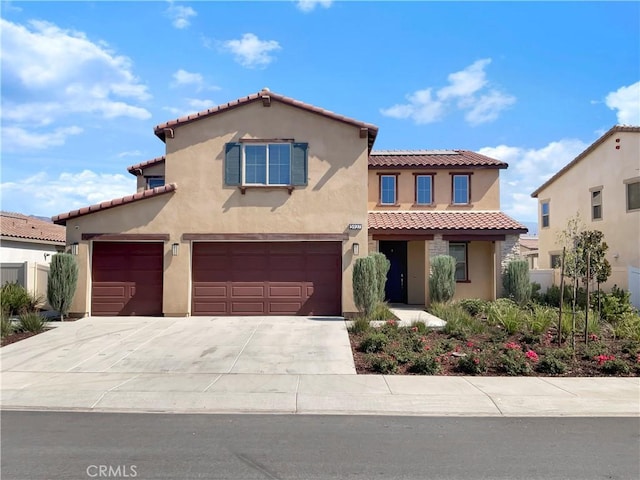 mediterranean / spanish-style home with a garage