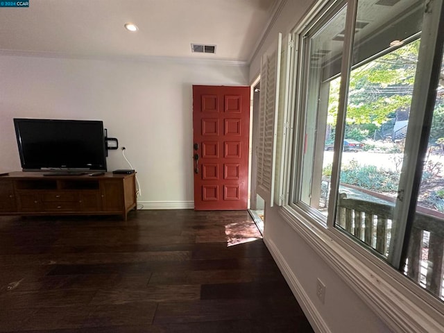 foyer entrance with crown molding and dark hardwood / wood-style flooring