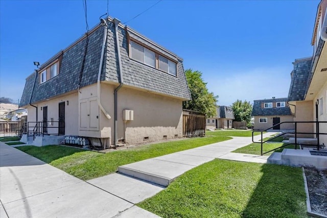 view of side of home with a lawn