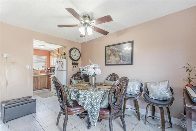 dining room with ceiling fan and light tile patterned floors