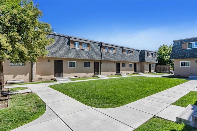 view of property featuring a front lawn