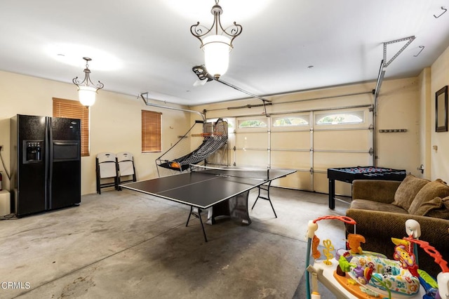 garage featuring black refrigerator with ice dispenser