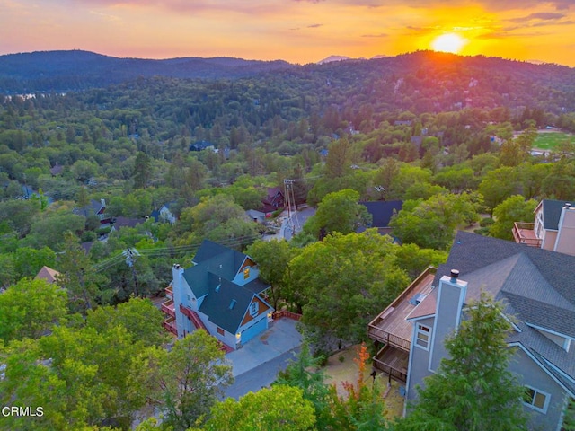 aerial view at dusk featuring a mountain view