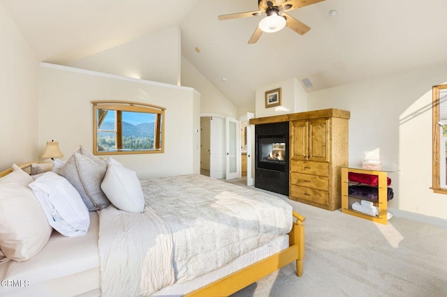 bedroom featuring ceiling fan, a multi sided fireplace, light carpet, and high vaulted ceiling