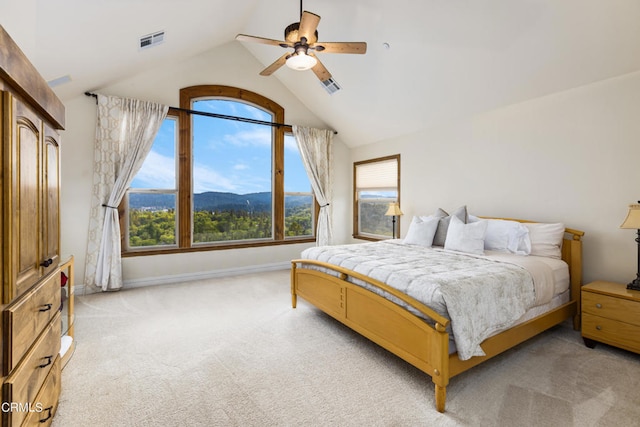 bedroom featuring a mountain view, multiple windows, light colored carpet, and ceiling fan