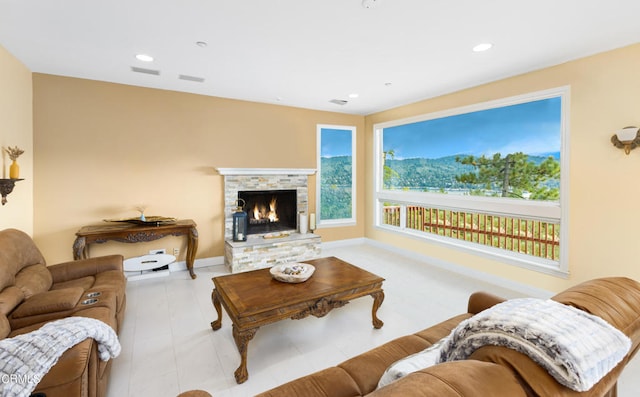 living room with a stone fireplace