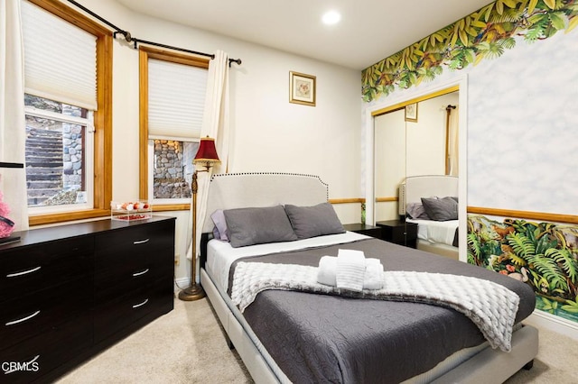 bedroom with a closet and light colored carpet