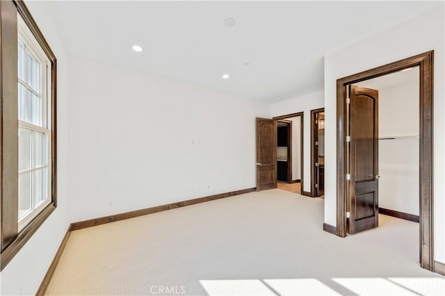 unfurnished bedroom featuring light colored carpet