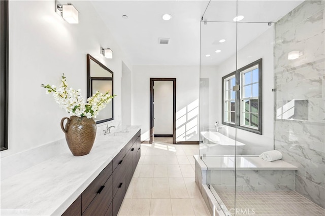 bathroom with independent shower and bath, tile patterned flooring, and vanity