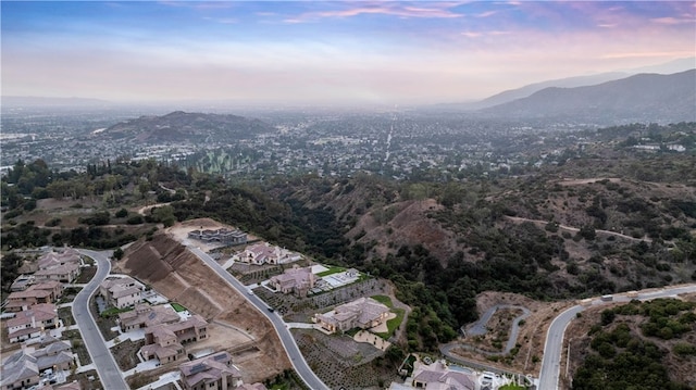 aerial view at dusk featuring a mountain view