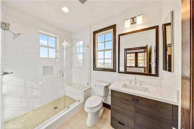 bathroom with tile patterned flooring, an enclosed shower, vanity, and toilet