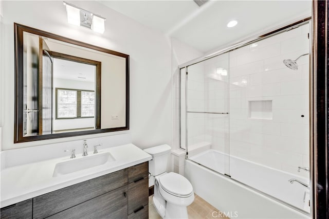 full bathroom with shower / bath combination with glass door, vanity, and toilet