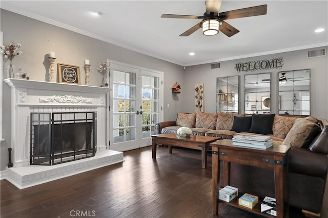 living room featuring crown molding, french doors, ceiling fan, and dark wood-type flooring