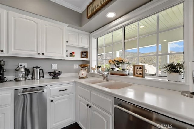 kitchen featuring white cabinets, stainless steel dishwasher, ornamental molding, and sink